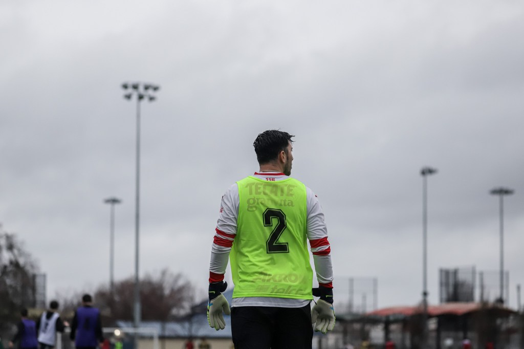 Goalkeeper standing on the pitch with his back to the camera at Republic FC's 2023 Open Tryouts.